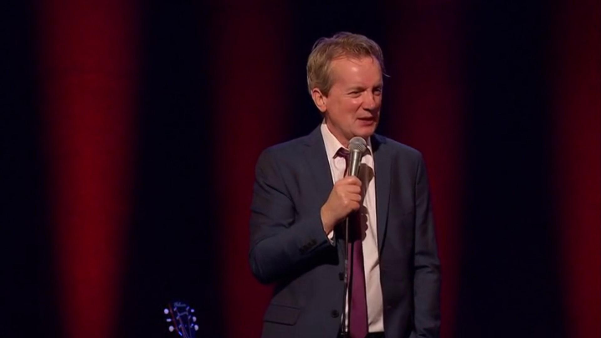 Frank Skinner Live - Man in a Suit Background